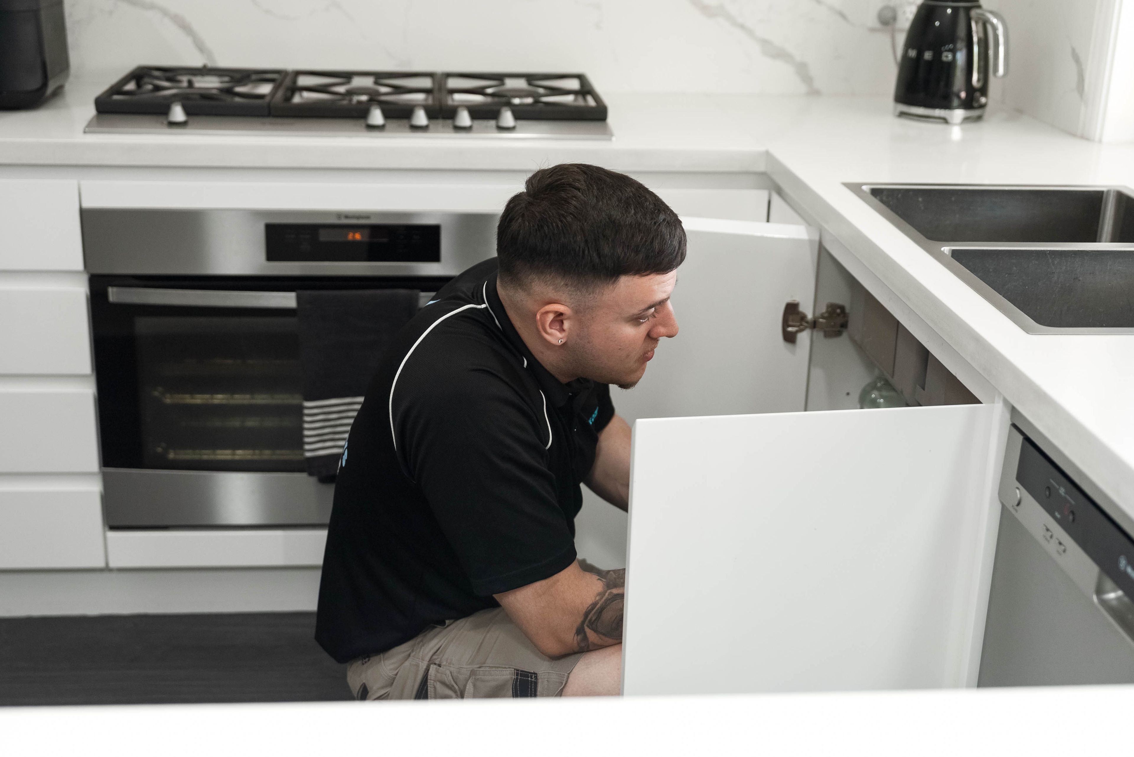 Plumber fixing a tap