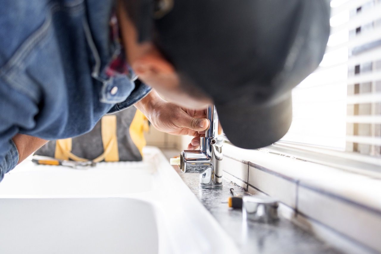 Plumber fixing a tap